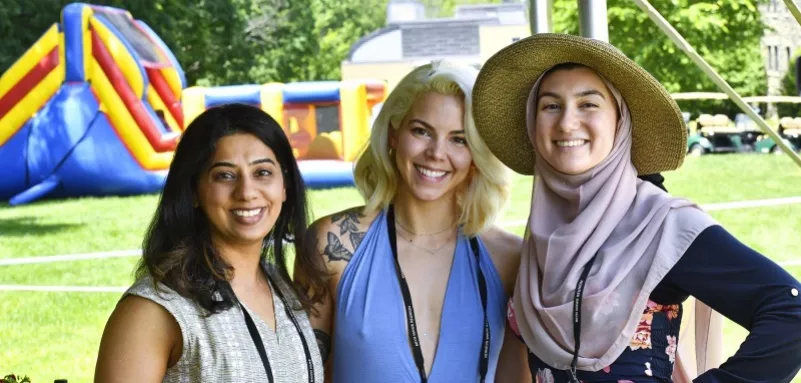 Three alumnae at an event