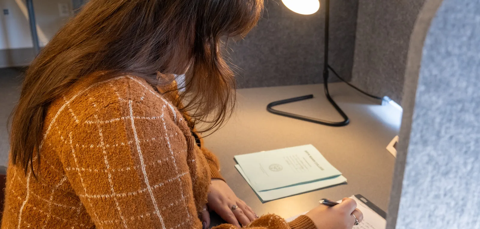 student sitting at a desk in the testing center