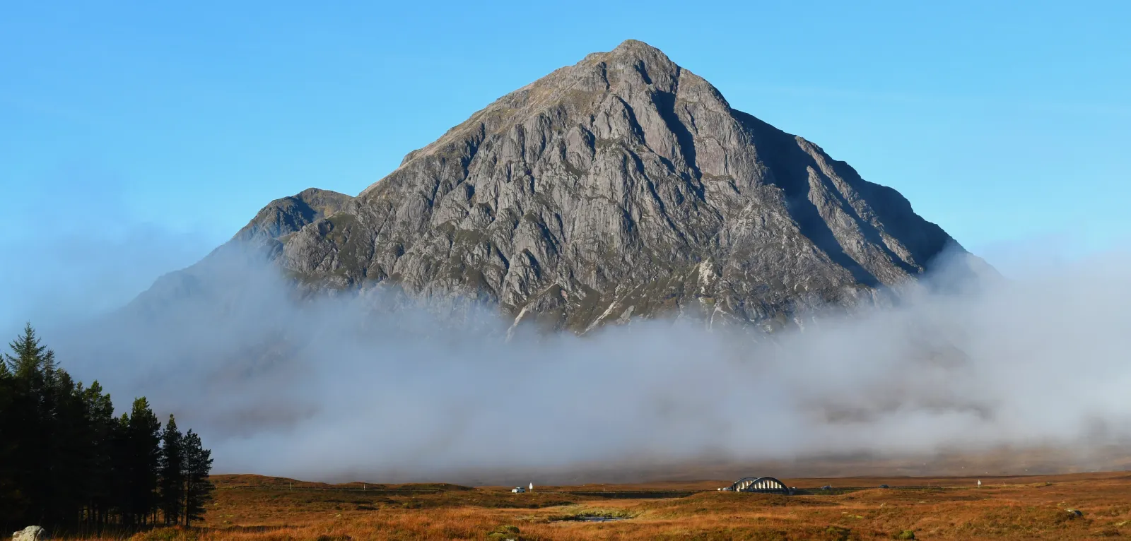 an image of a mountain in Scotland rising out of a cloud of mist