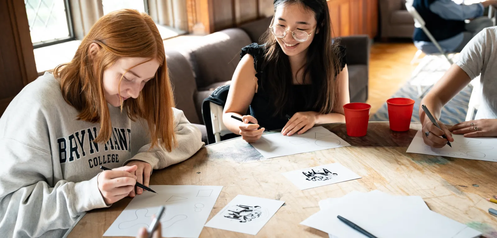 Students work on their single-panel cartoons at the Cartoon Workshop. Photo by Caroline BIttenbender.