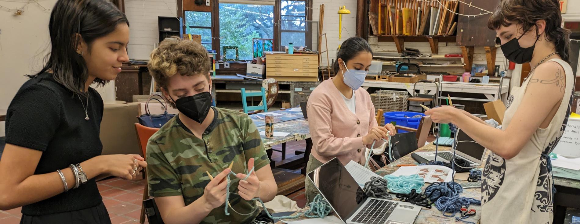 Students work on tapestries representing sulfur dioxide emissions from coal-fired power plants