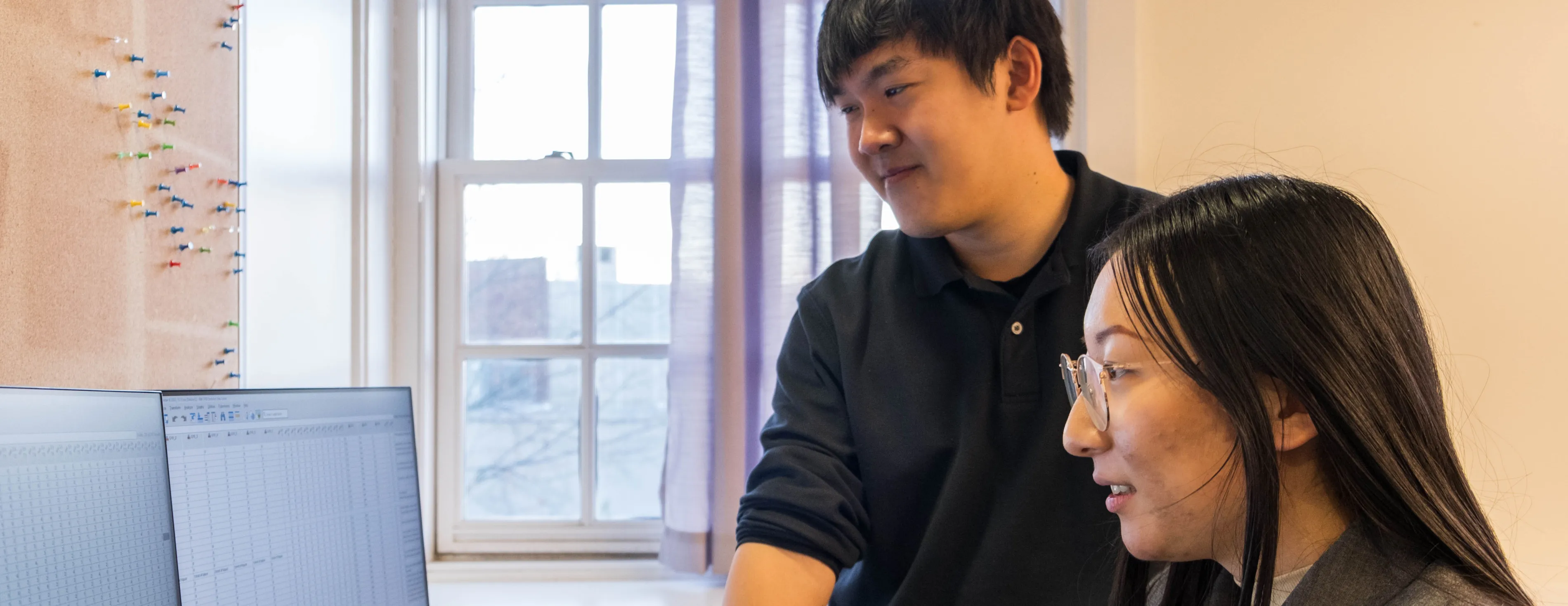 Thomas Le and a student at a computer