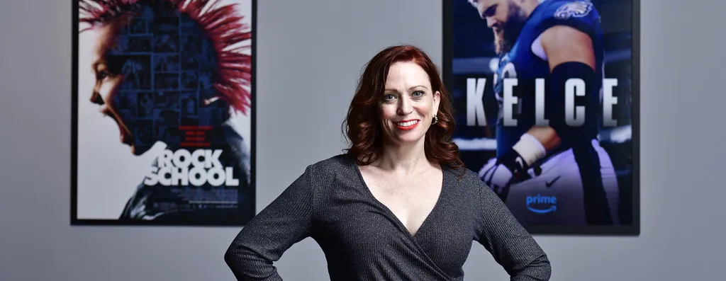 Sheena Joyce posing in front of two movie posters