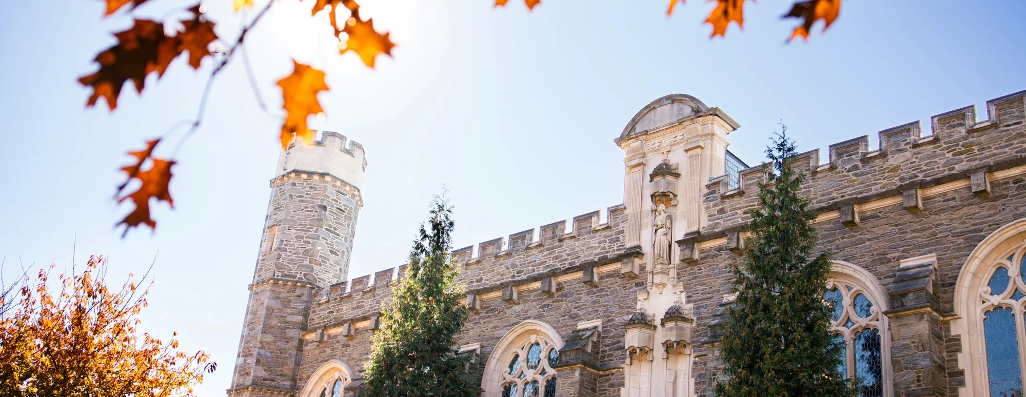 the exterior of great hall with autumn foliage