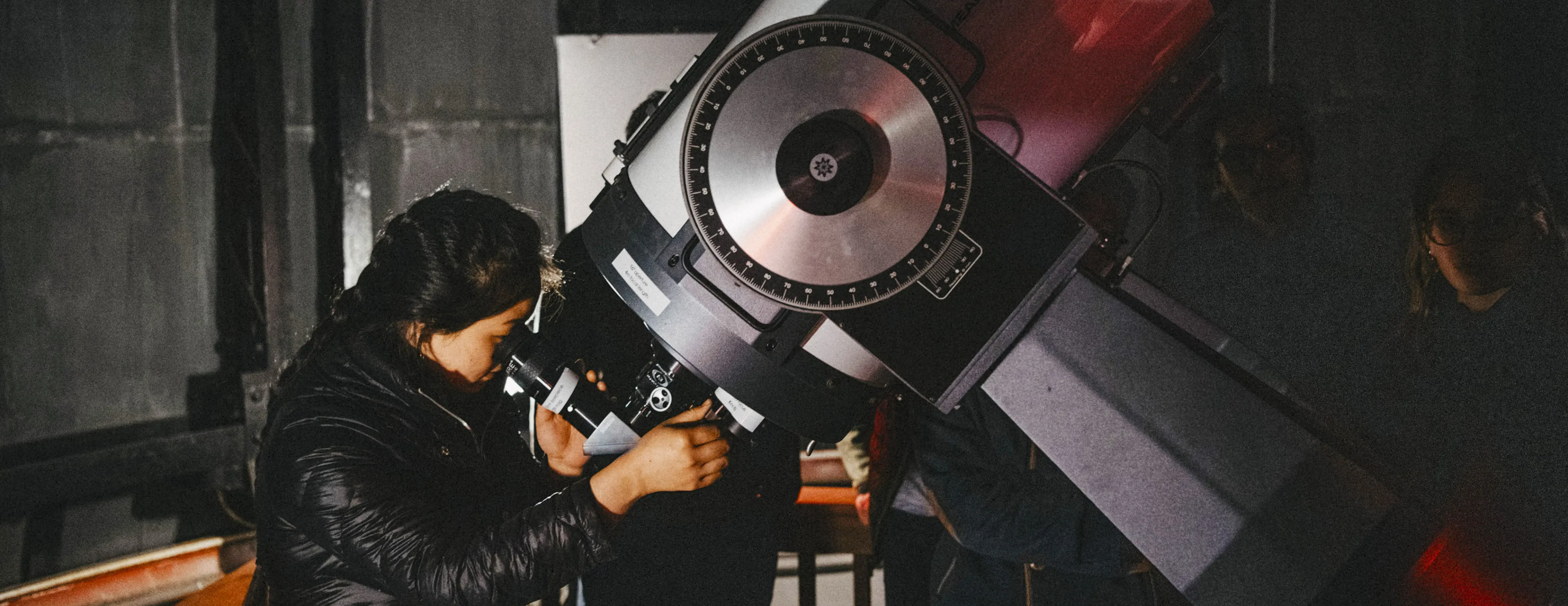 A Bryn Mawr Astronomy student looks through the telescope at the Haverford College Holden observatory