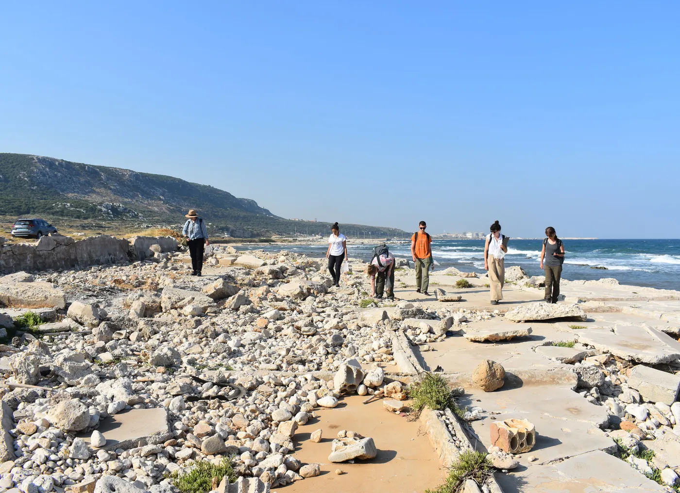 Classical and near eastern Archaeology students walking in sun bleached ruins