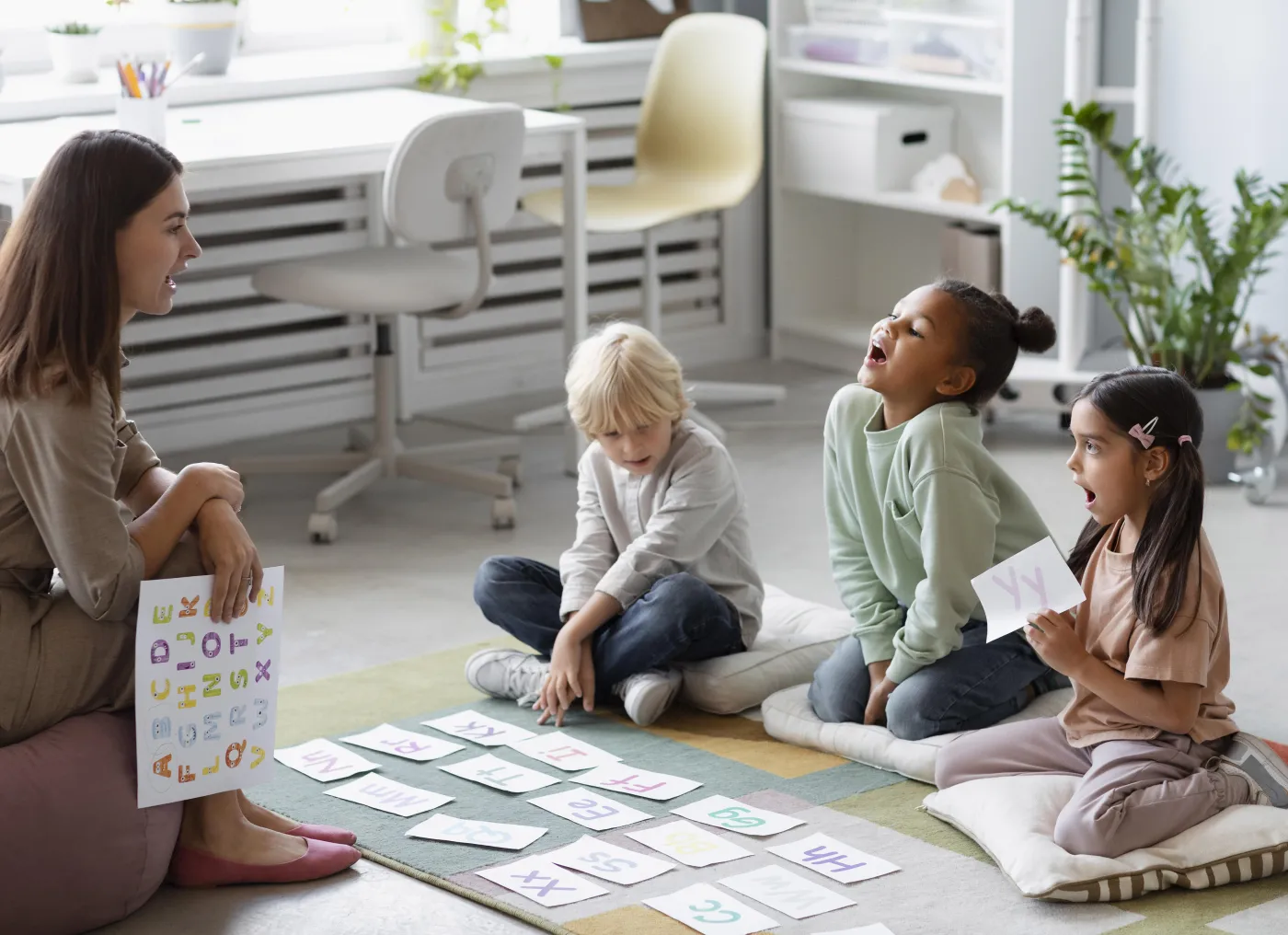 Young teacher does speech therapy with kids