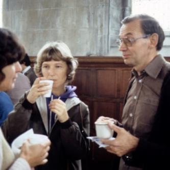 Faculty member and students drinking coffee