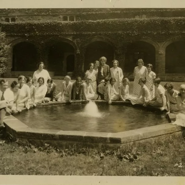 Students standing around a large water fountain