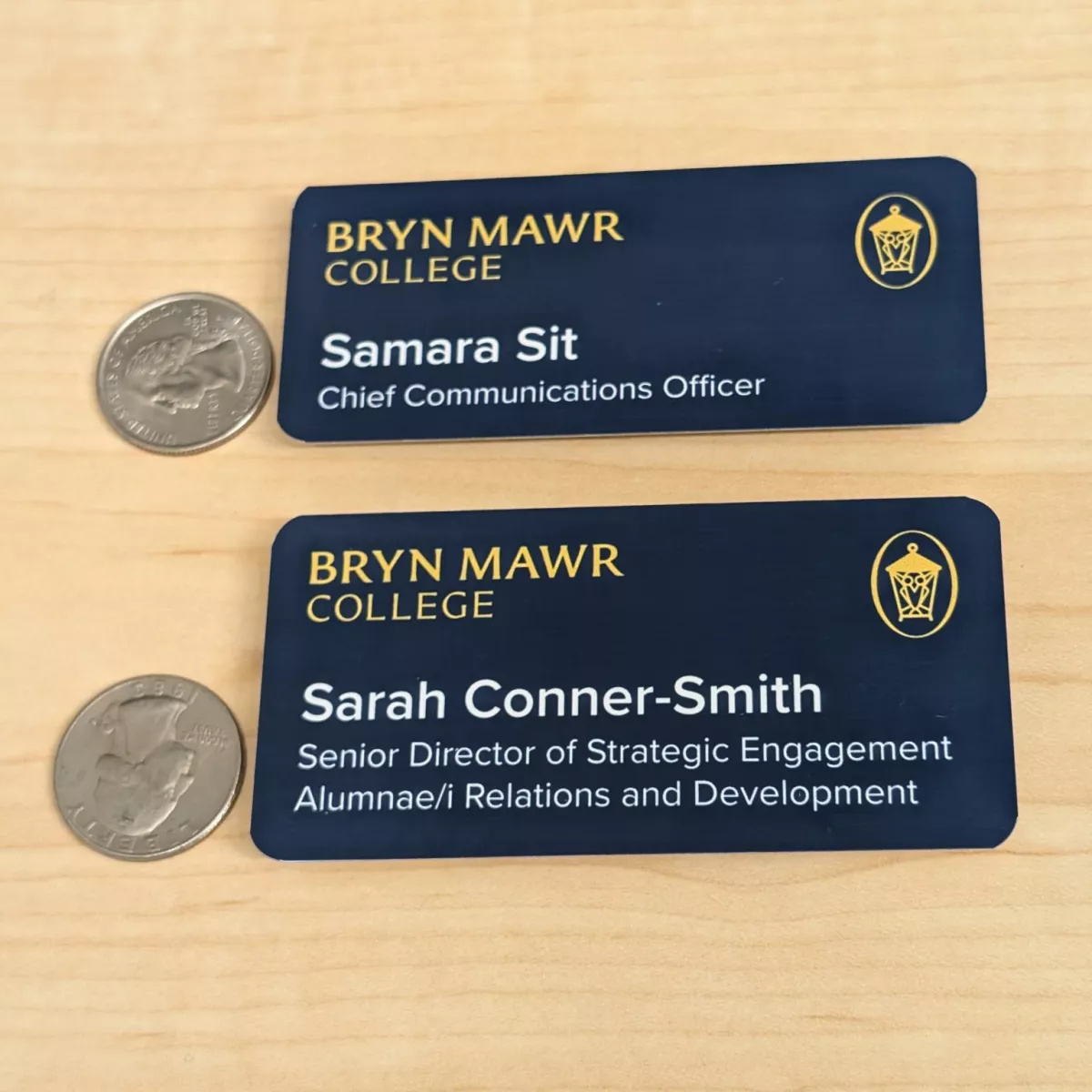 two blue nametags with yellow and white text