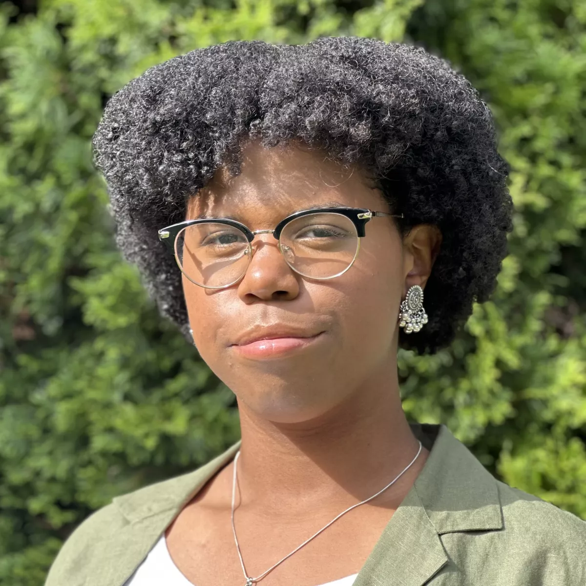 Kaili in a green and white shirt, wearing glasses