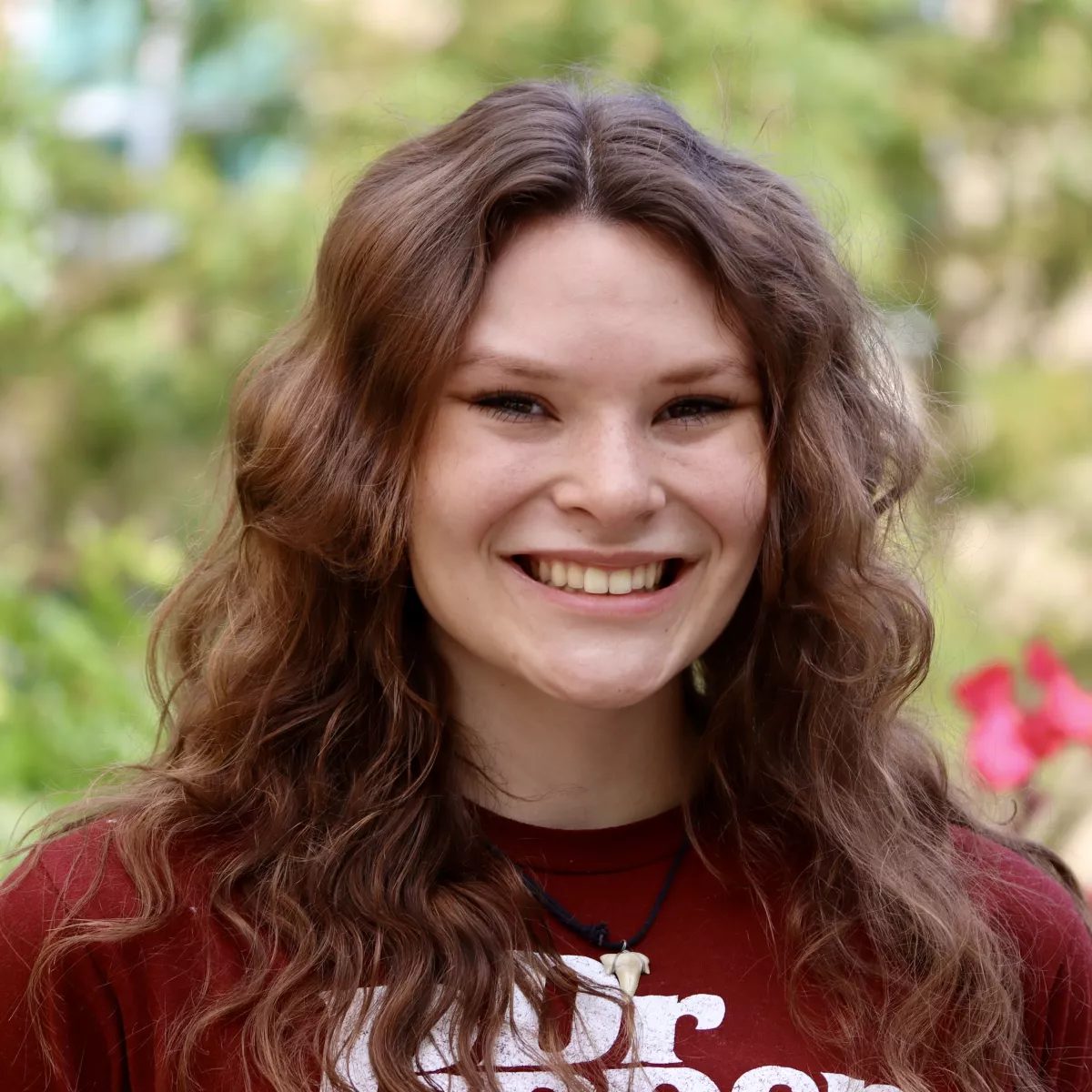 Joelle in a maroon Dr. Pepper shirt