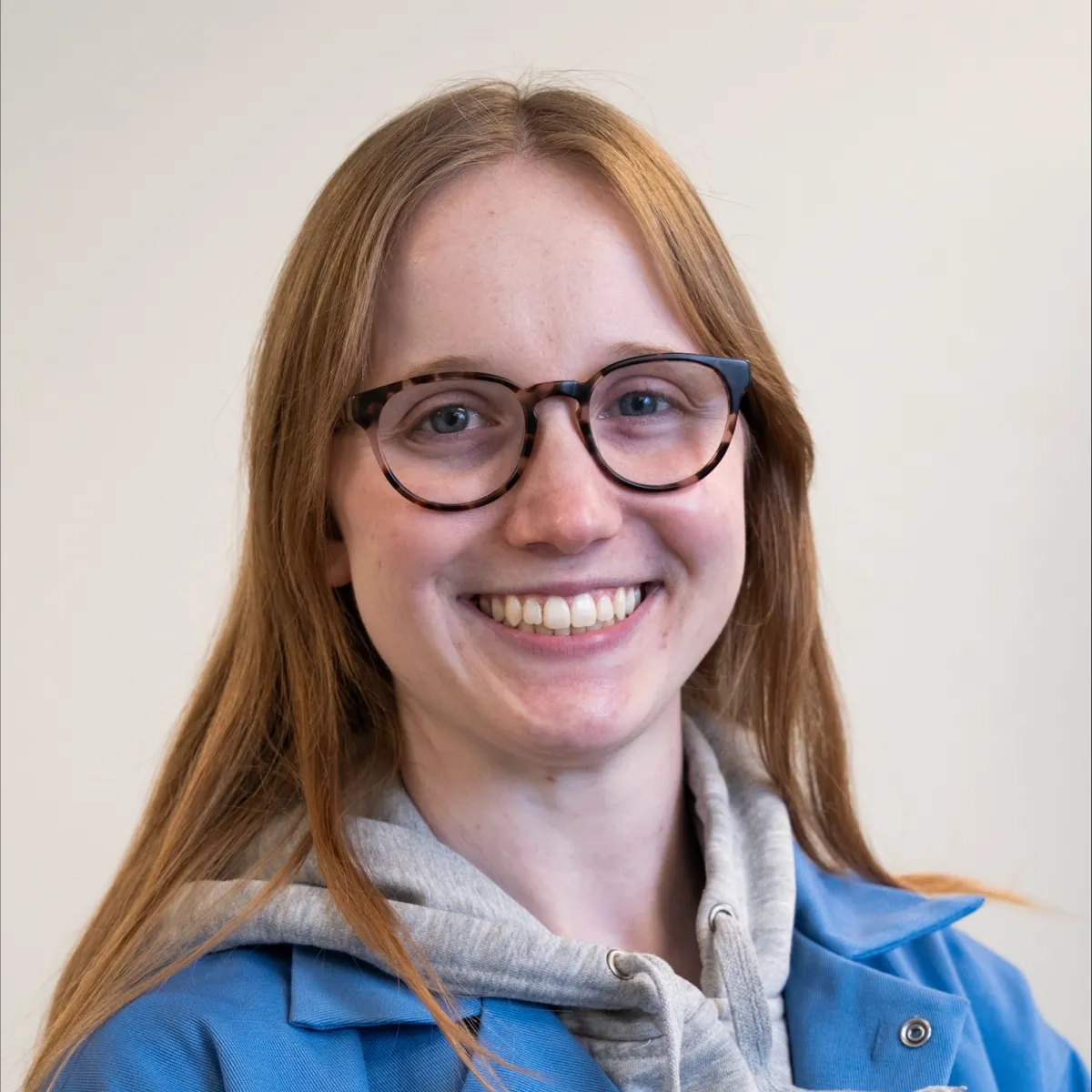 A headshot of Sonja in blue lab gear