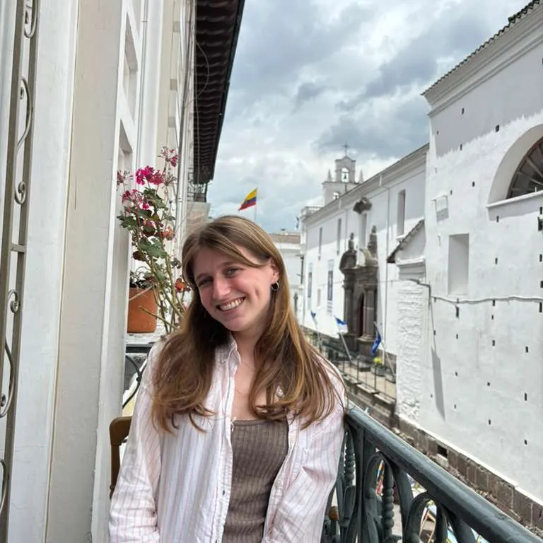Celia standing on a balcony in Quito, Ecuador