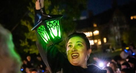 Emily Friedman '03 holding lantern at Reunion Step Sing.