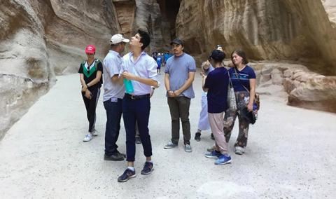 Students at the Siq, the entrance to the ancient city of Petra.