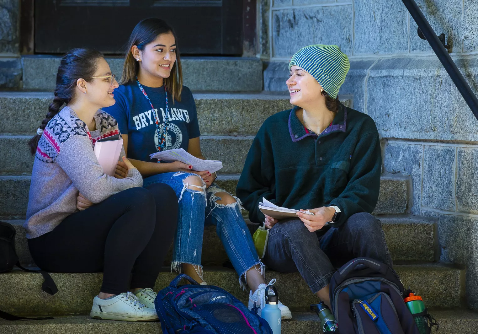 students sitting on steps at merion hall