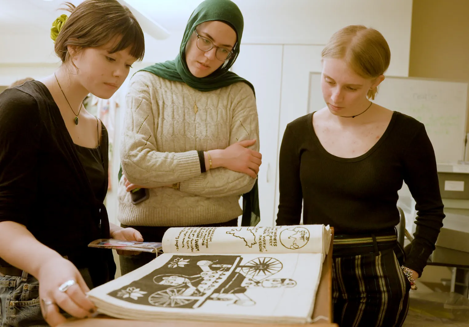 students gathered around a text