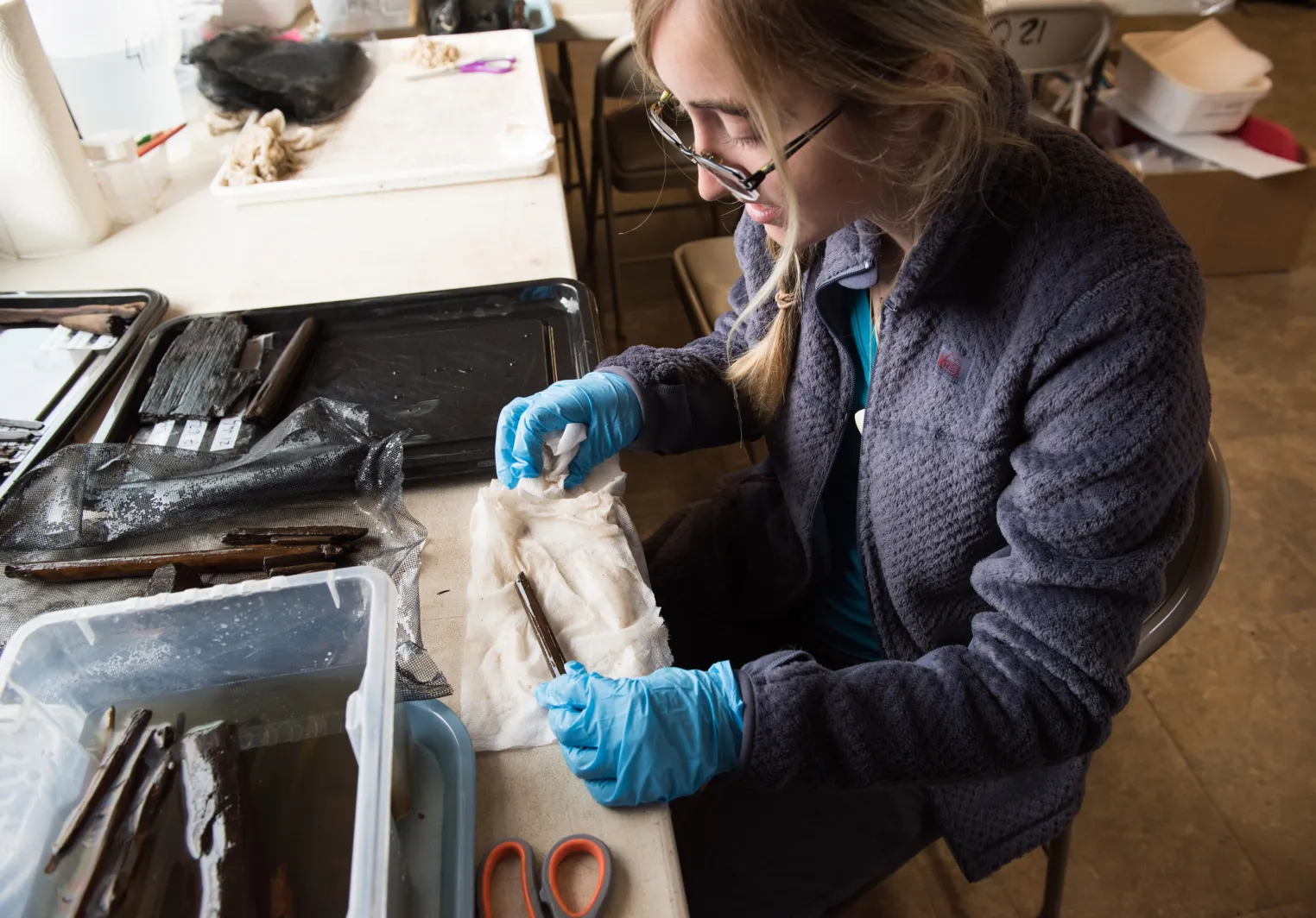 A Bryn Mawr College student intern working on artifacts in Alaska
