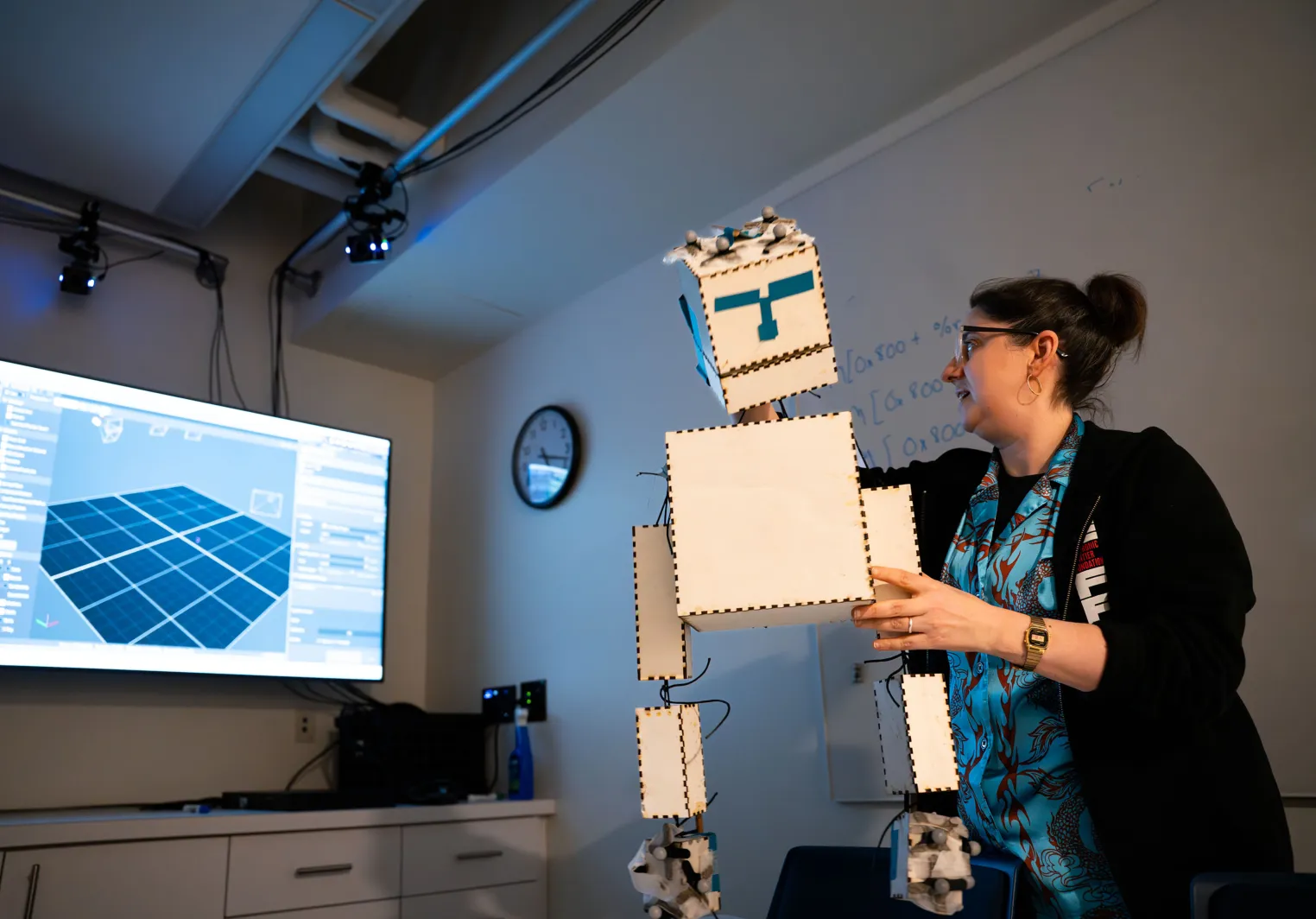 A professor or Computer Science manipulates a cardboard puppet