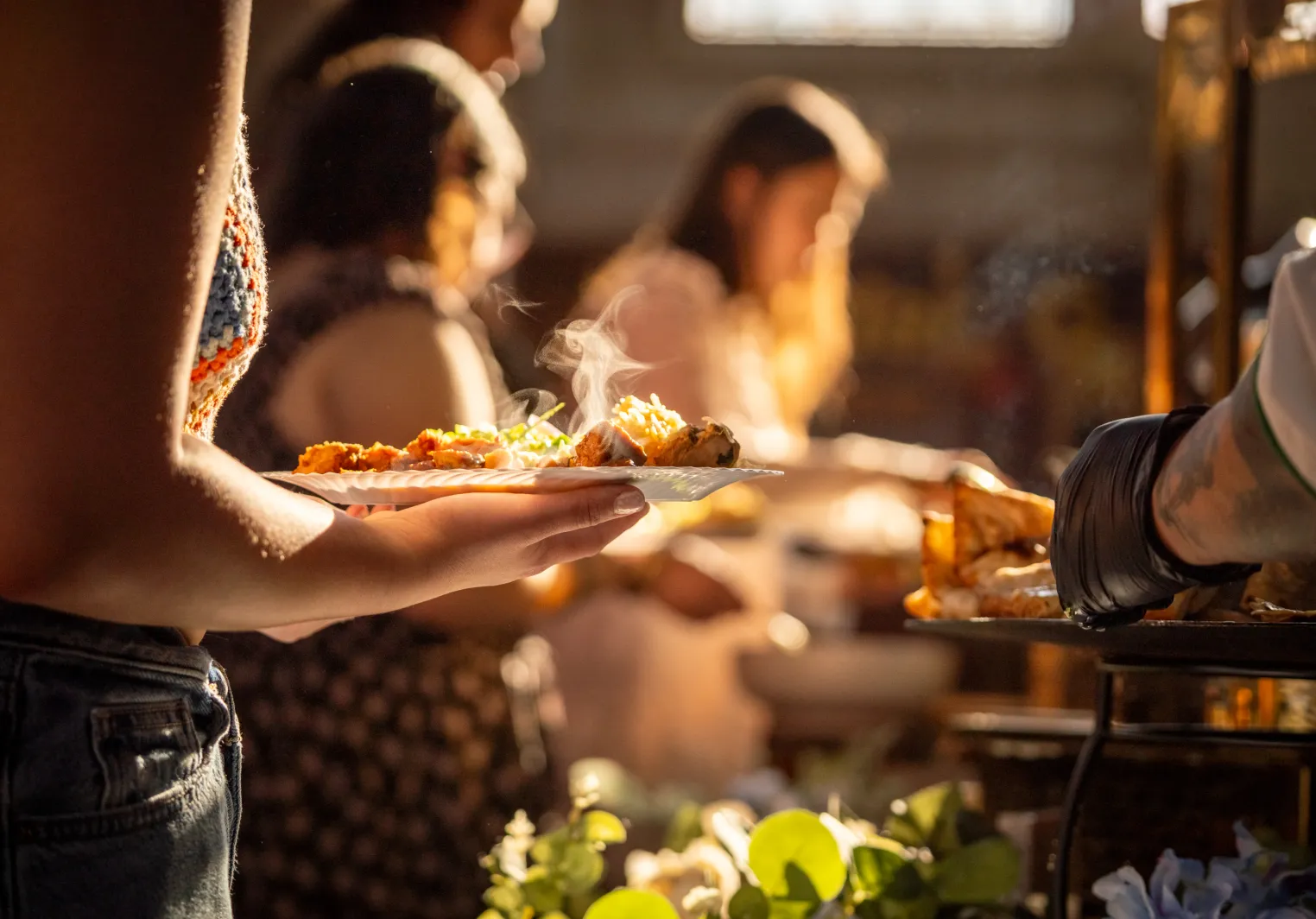 Student being served a meal at an outdoor Bryn Mawr College campus dining event