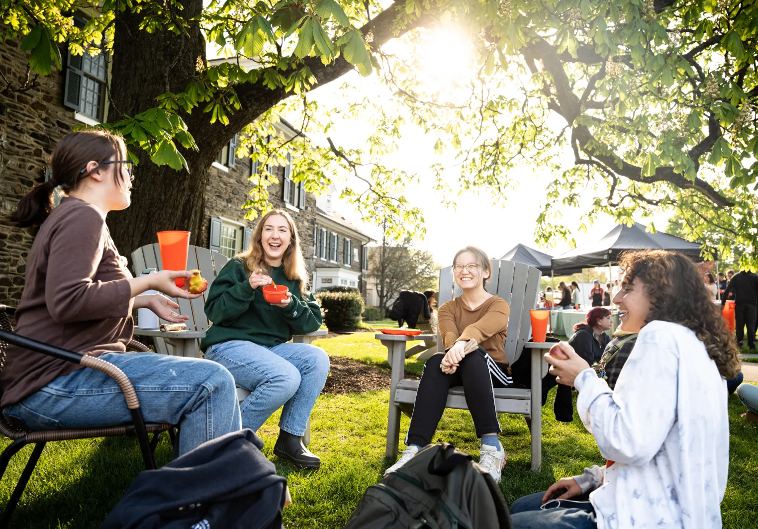 Bryn Mawr College students enjoying outdoor campus dining and conversation.