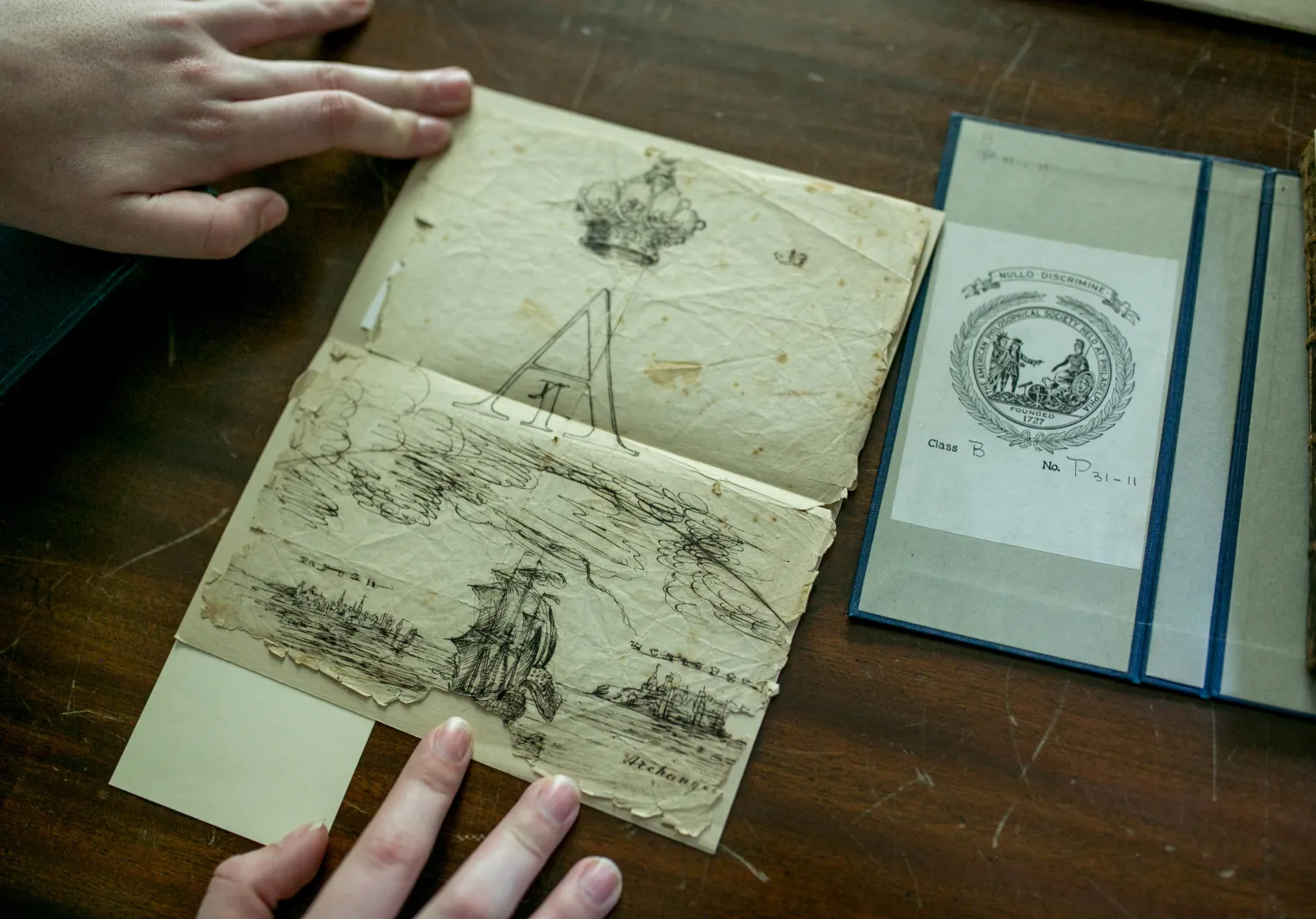 A Bryn Mawr student intern handles an antique document