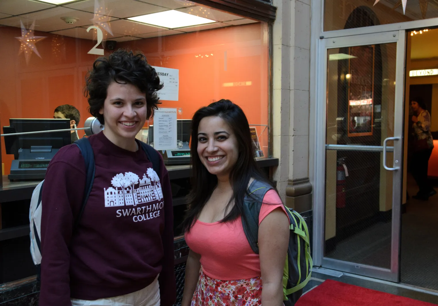 Two Tri-Co students stand inside the Bryn Mawr Film Institute