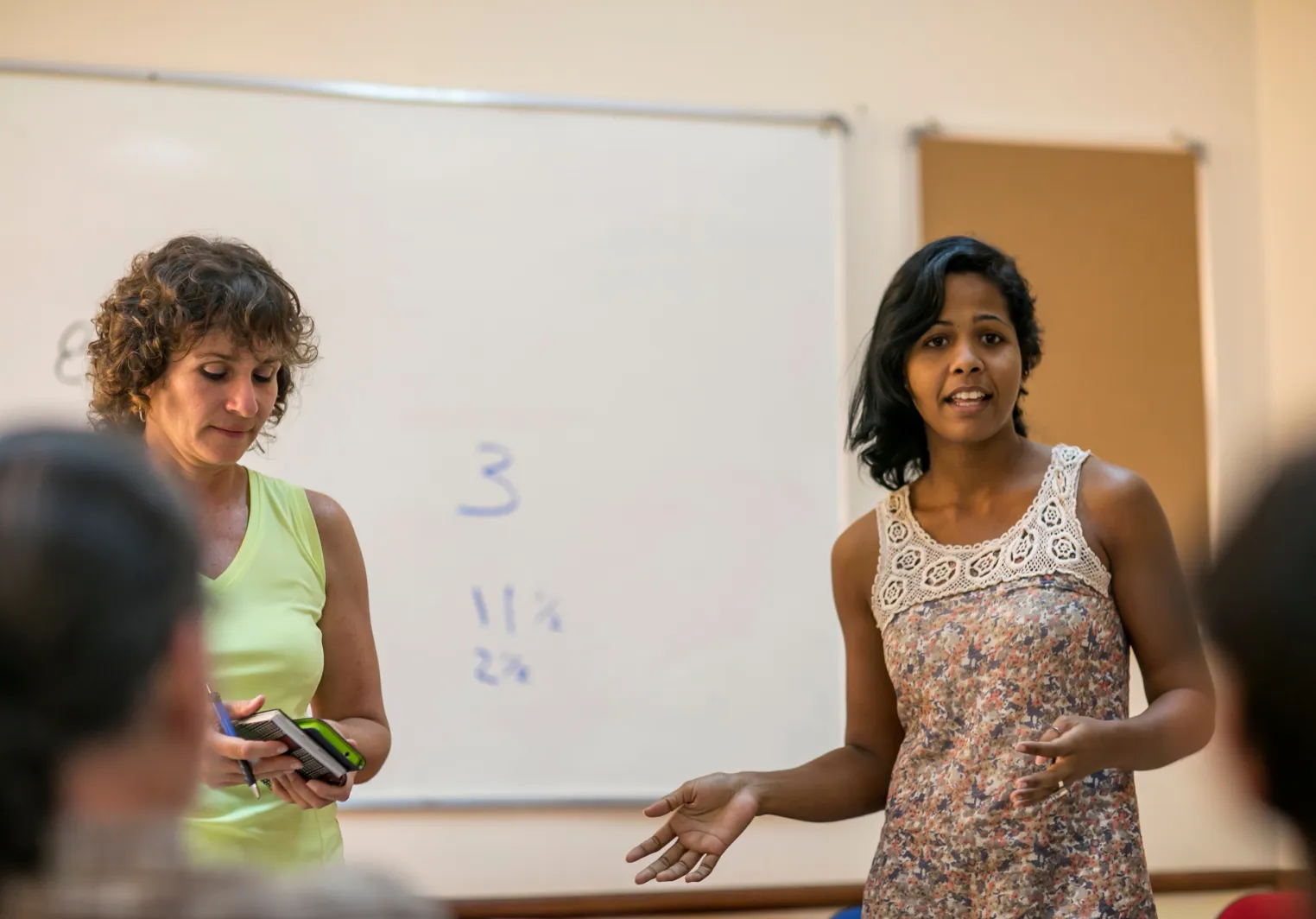 Two women talk about economics in class