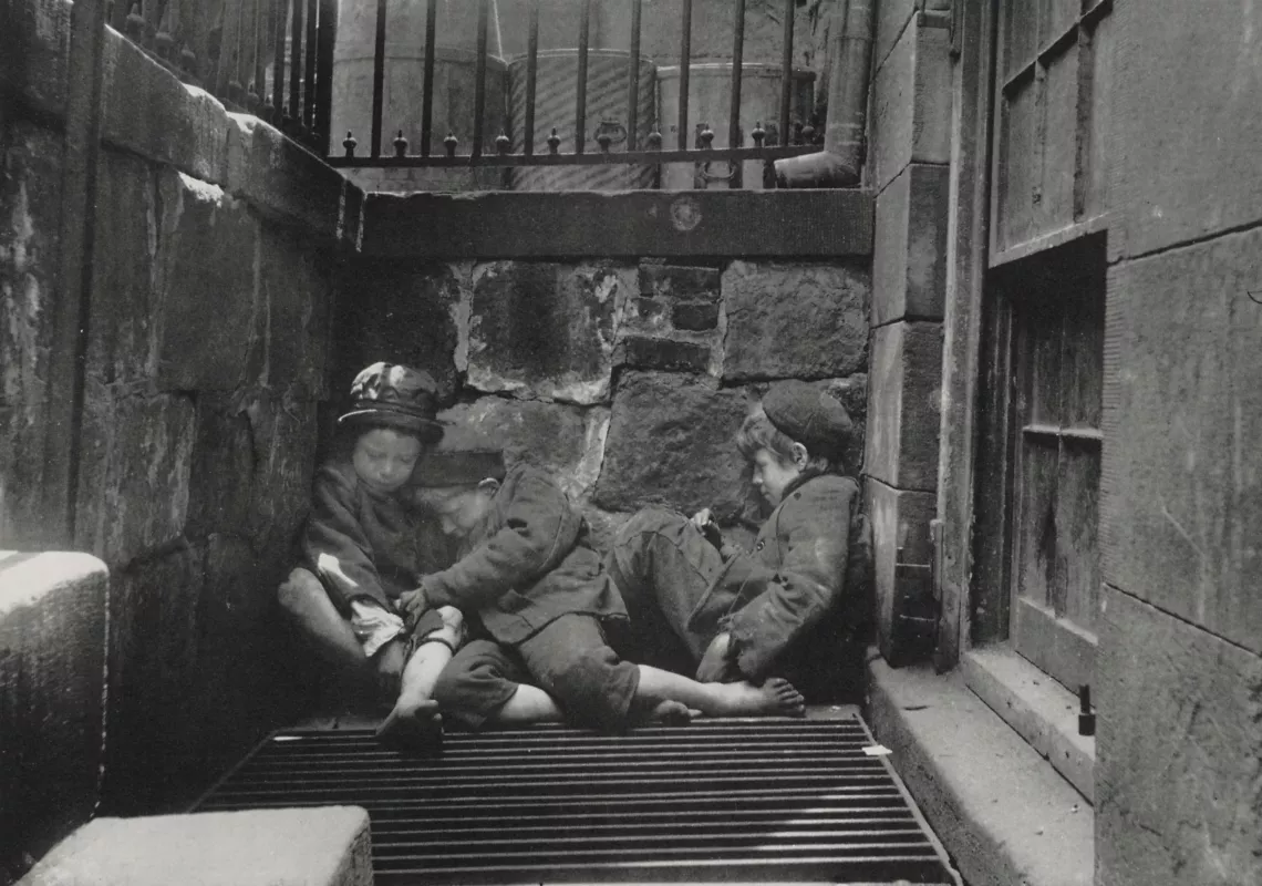 A photo by Jacob Riis of children sleeping in the street.