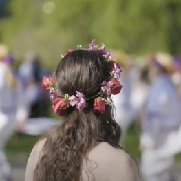 Image of a student wearing a flower crown during Grand May Day 2022.