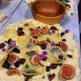 Butter board decorated with figs, lemons, and berries