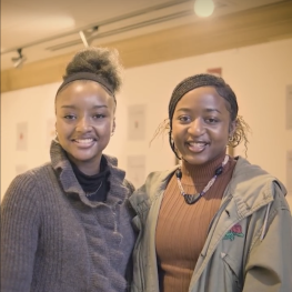 Sisterhood Student Coordinators Bintou Dembele and Alloyah Abobi standing next to each other in the ECC Library 