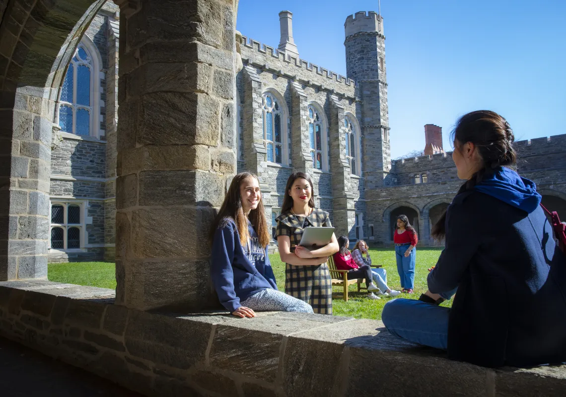 Students sitting and talking in the Cloisters