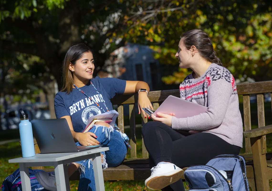 students sitting on bench talking