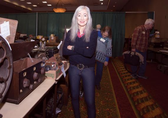 Barbara Kevles standing near vintage equipment
