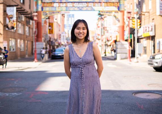 Kaia Chau standing in front of the Philadelphia Chinatown Gates