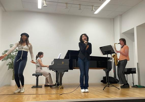 Jade Poli '25 rehearsing with other interns before their performance at the festival