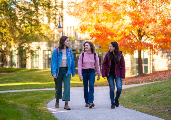 Isabelle Stid, Helen Ehrlich, and Lia Wong-Fodor walking past Carpenter Library