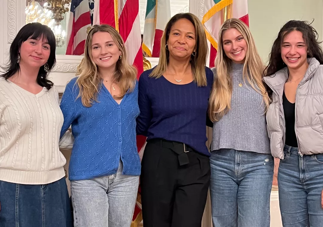 Group photo of four Bryn Mawr students and Daniela Ballard '90 in the US Consulate in Florence, Italy. 