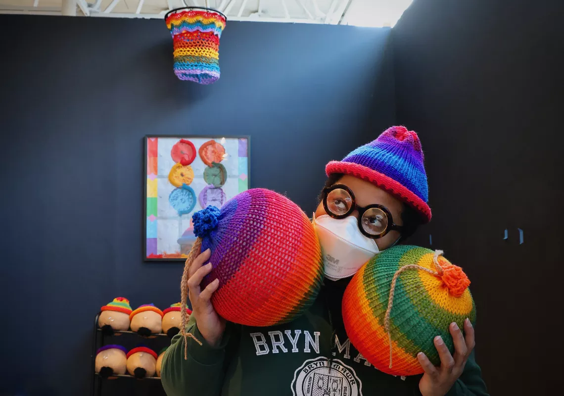 Wit López photographed in The Galleries at Moore with their artwork. Photo by Emma Lee, WHYY