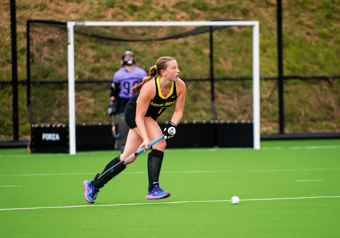student playing field hockey