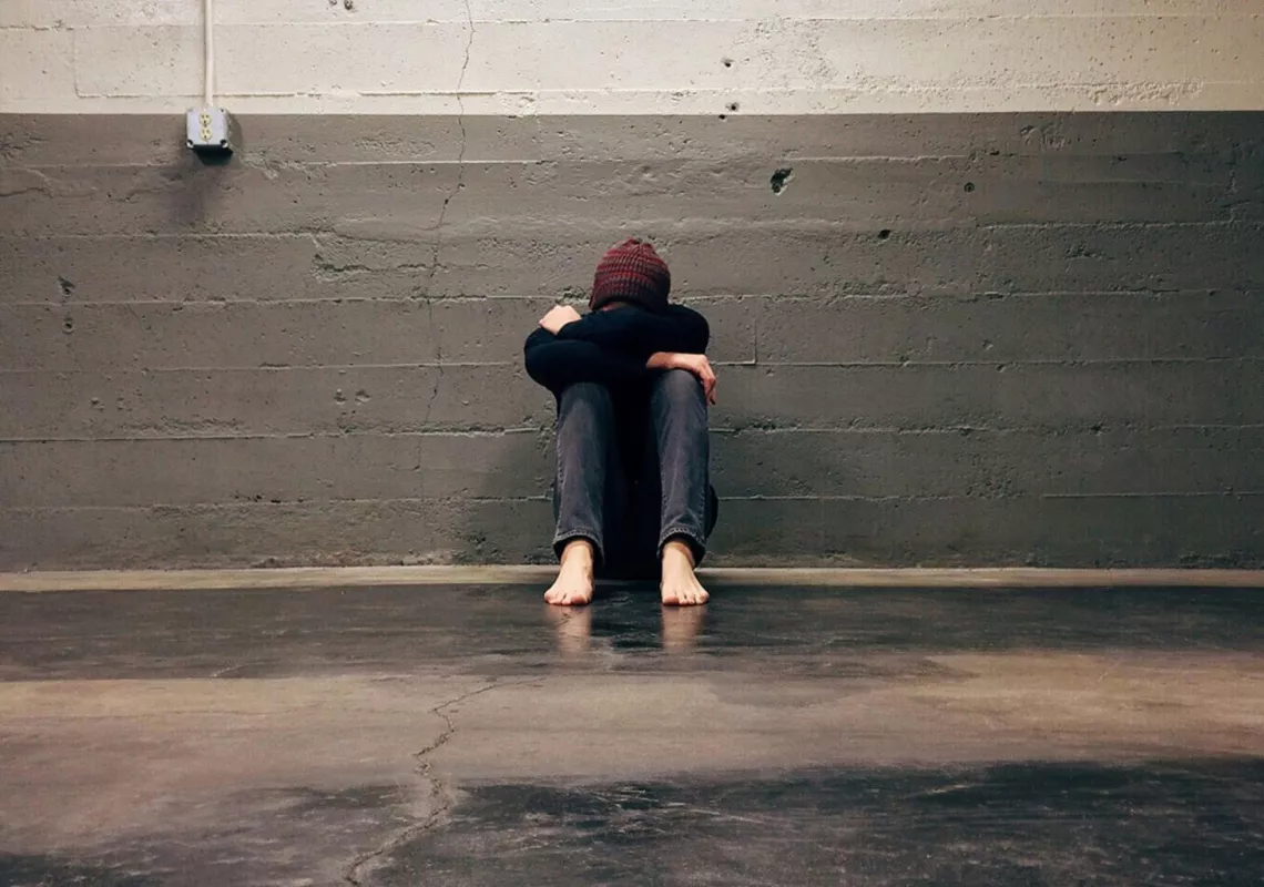 Boy sitting w/head in his hands