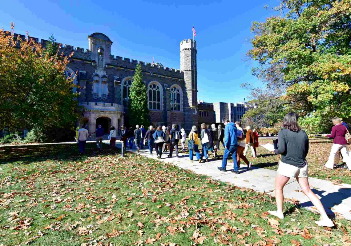 A group of students and family members walk towards Old Library
