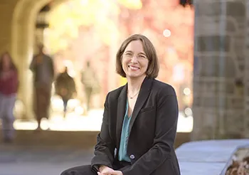 Wendy Cadge sitting on campus