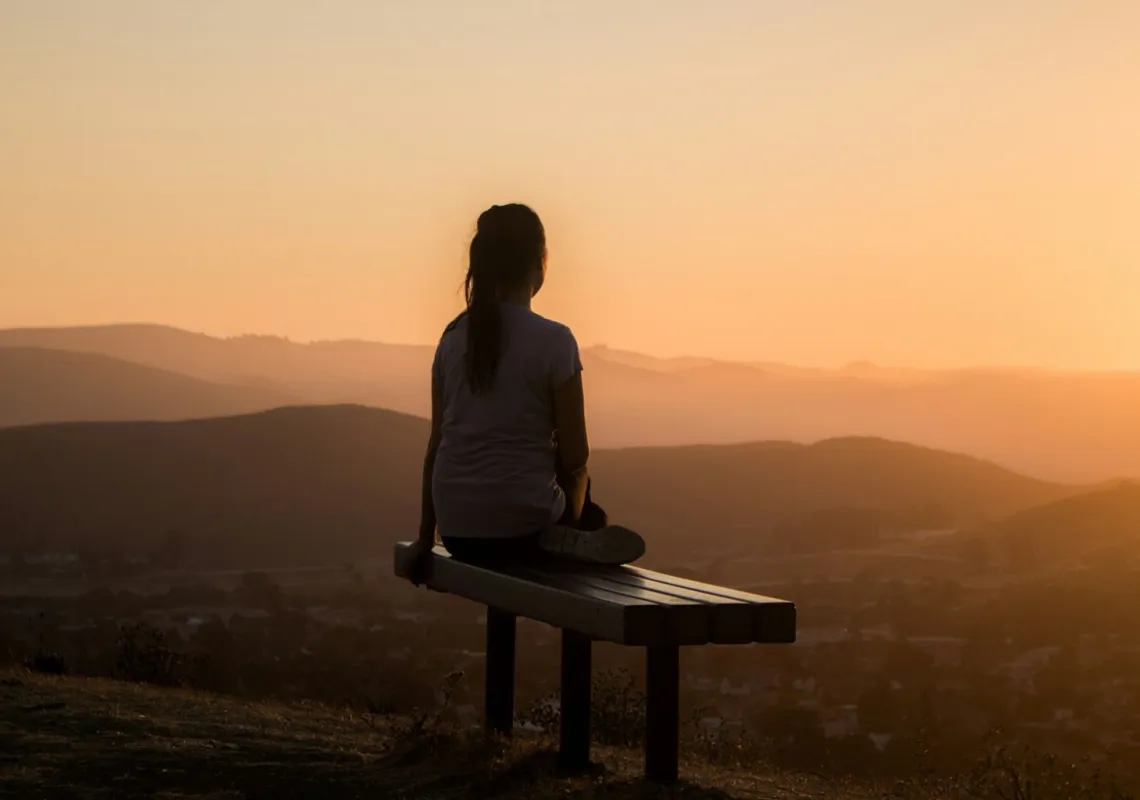 Woman meditating on bench