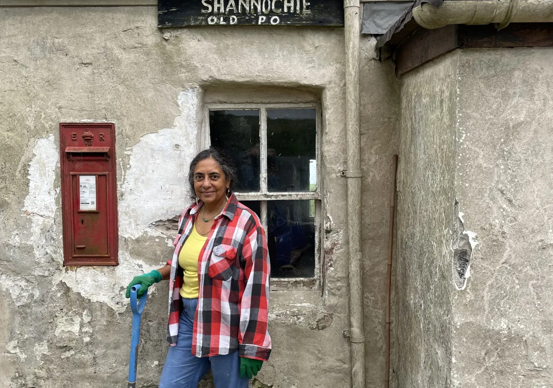 Michelle Valladares by the red postal box in her old post office on the Isle of Arran.