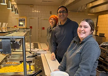 Staff helping to serve food at Midnight Breakfast 2025