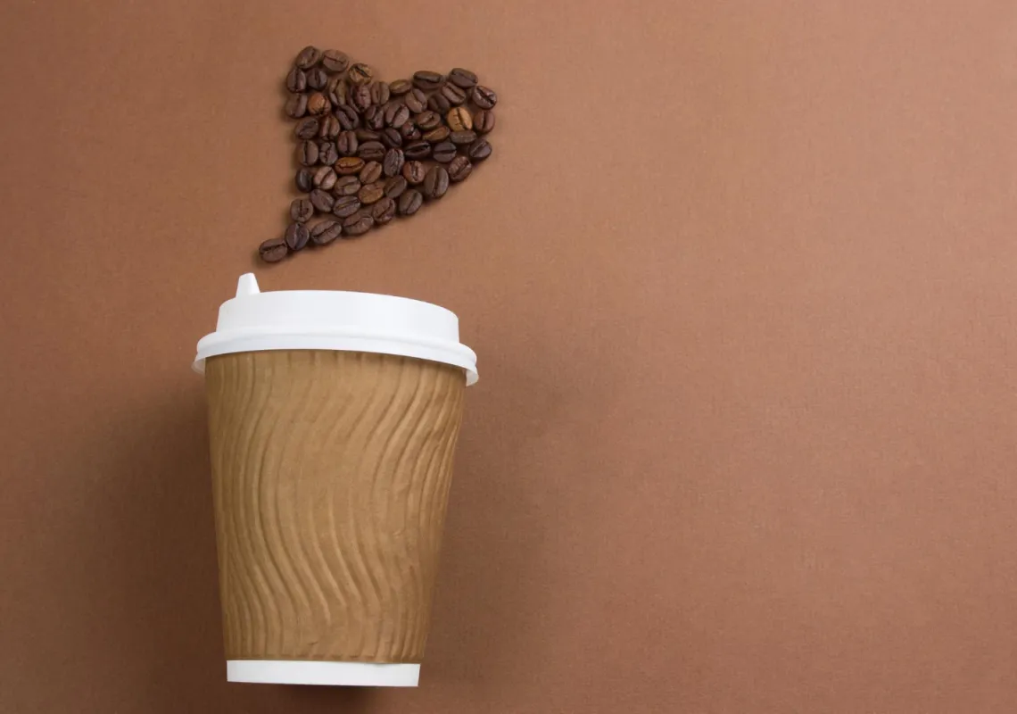 To go coffee with beans shaped in heart