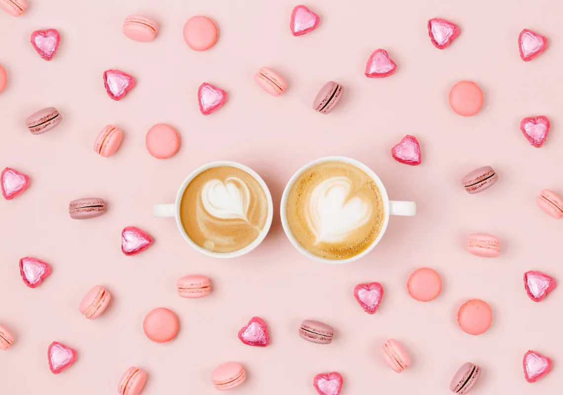 coffee-cups-with-candys-macaroons-pale-pink-background